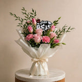 Luxury graduation bouquet with acrylic topper reading "عمتي احلى خريجة" for celebrating aunt graduation in UAE