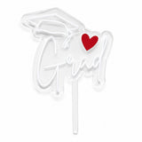 Clear acrylic Grad cake topper with white acrylic lettering, graduation cap, and red heart.
