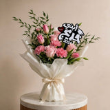 Luxury graduation bouquet with acrylic topper reading "ابني احلى خريج" for celebrating son graduation in UAE